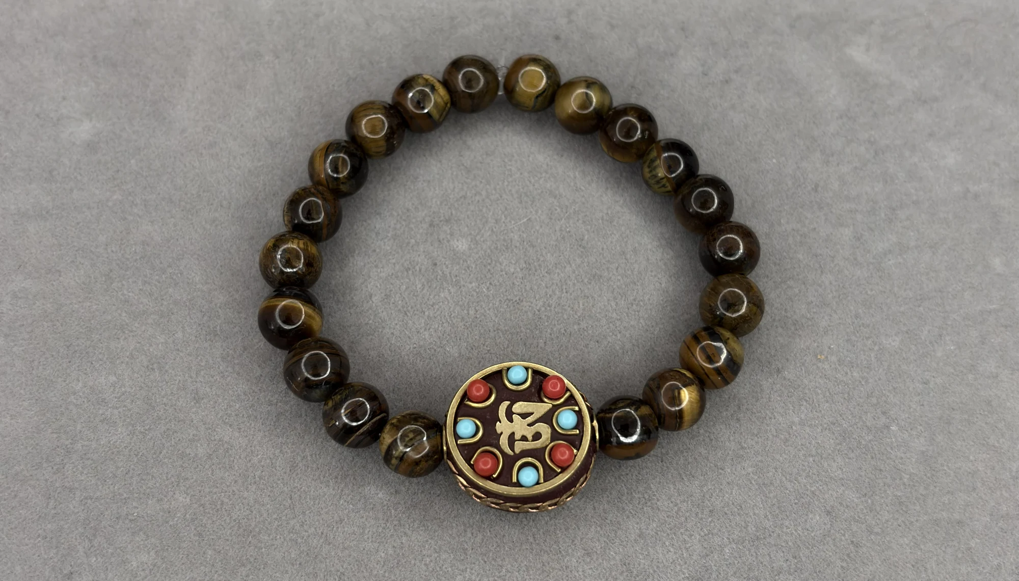 Pulsera Ojo de Tigre + dije Tibetano