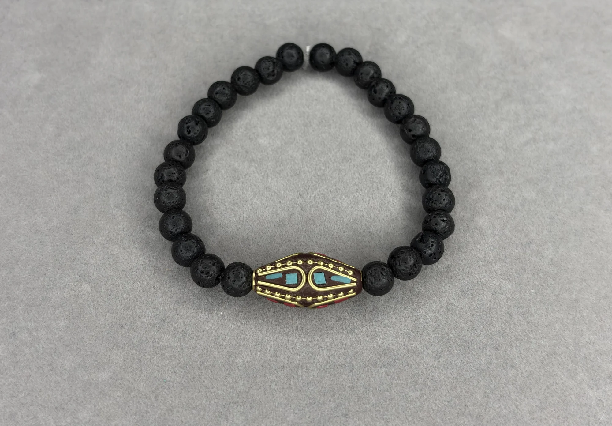 Pulsera Piedra Volcánica + Dije Tibetano